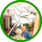 Eine Grafik mit einer weißen Rose überlagert ein unscharfes Bild von zwei älteren Menschen, die nebeneinander sitzen, eingerahmt von einem grünen Kreis.